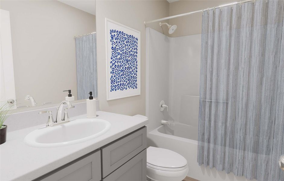 Bathroom with shower / bath combo with shower curtain, toilet, and vanity