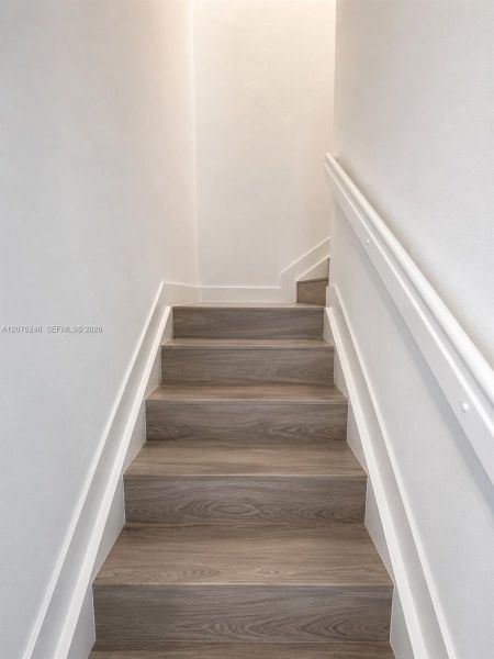 updated staircase with wood-look flooring