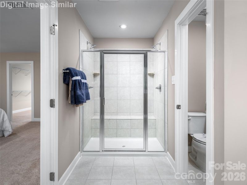 Optional Roman shower with built-in seat and dual shower heads — a spa-like experience right at home.