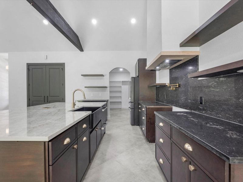 Enjoy this moody kitchen with two tone countertops that complement each other so well!