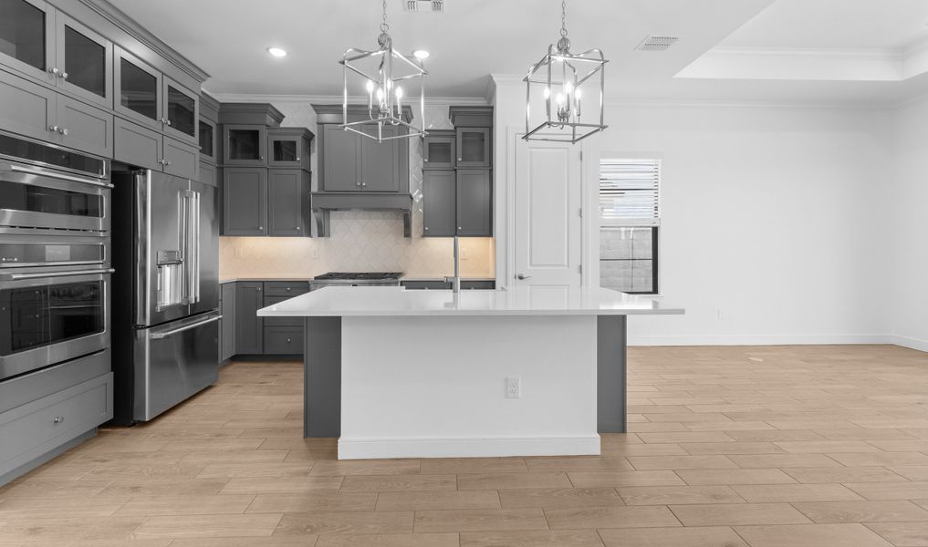 Kitchen with stacked glass-front upper cabinets