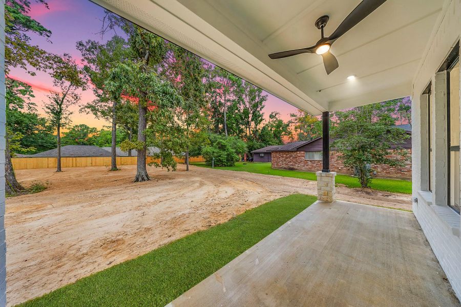 Cozy covered patio deck in the backyard, perfect for relaxing outdoors, entertaining guests, and enjoying the fresh air.