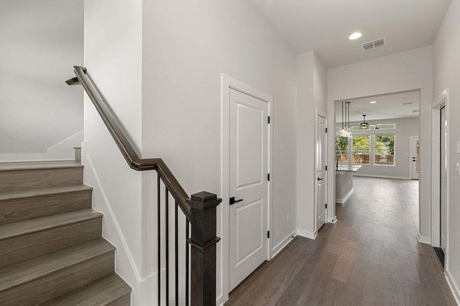 Staircase with wood finished floors, recessed lighting, and a ceiling fan