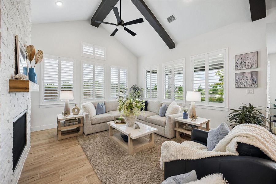 The living room features tranquil views of the patio, water and nature.