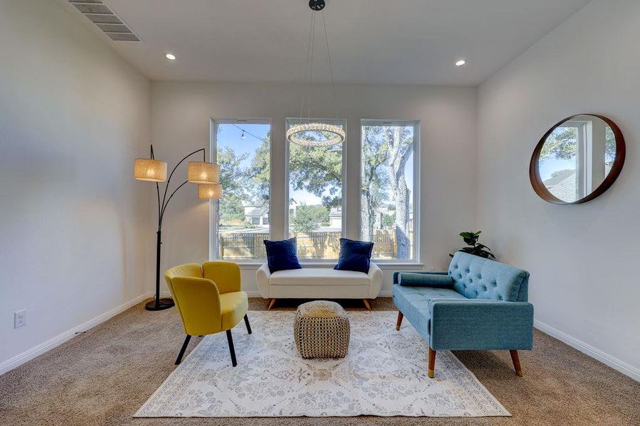 Primary Sitting room featuring healthy amount of natural light, carpet flooring, and recessed lighting