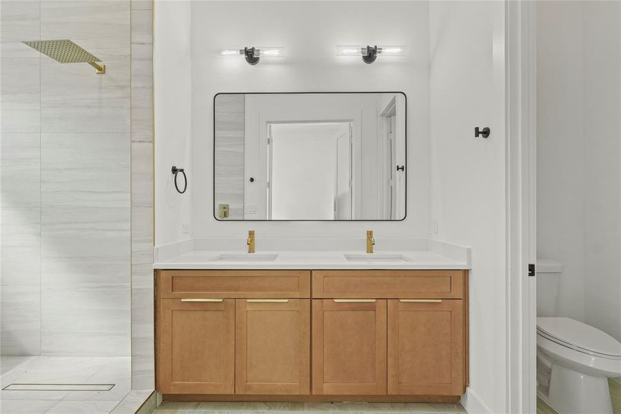 Full bathroom featuring walk in shower and double vanity