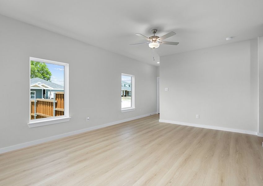Large living room with windows and ceiling fan