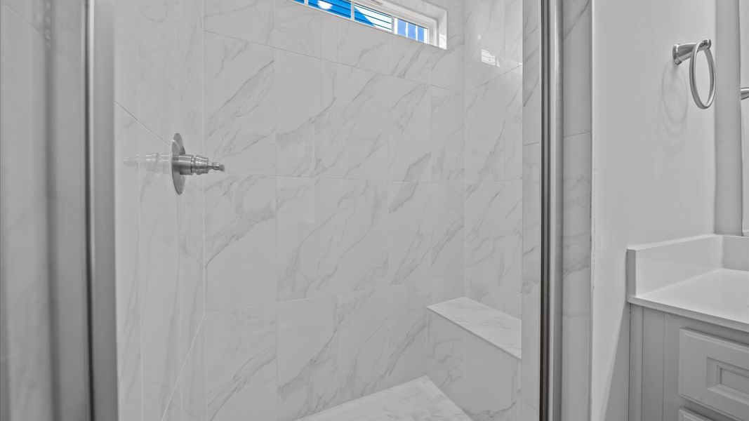 Highly functional and elegant en-suite with dual vanities, tiled walk-in shower, and refined finishes