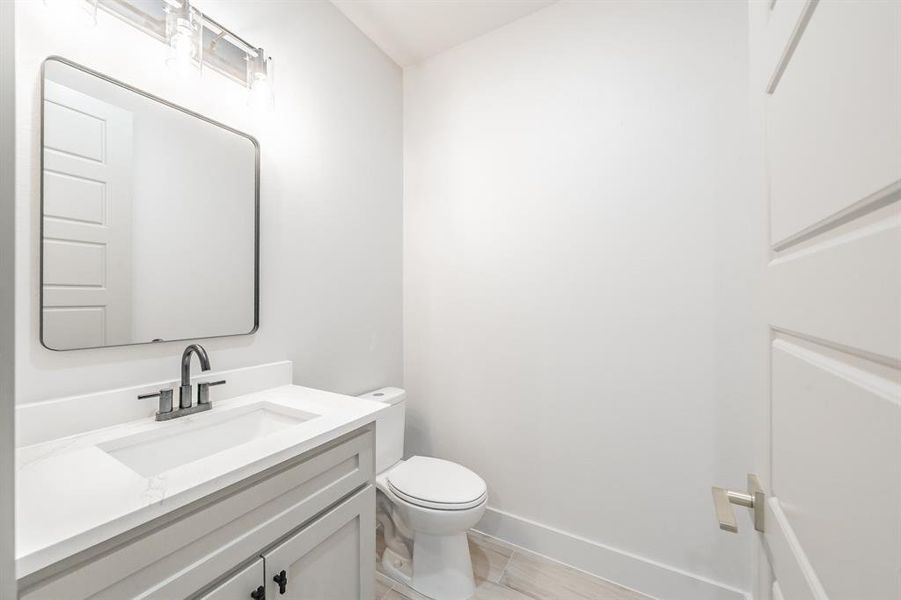 Bathroom with vanity and baseboards