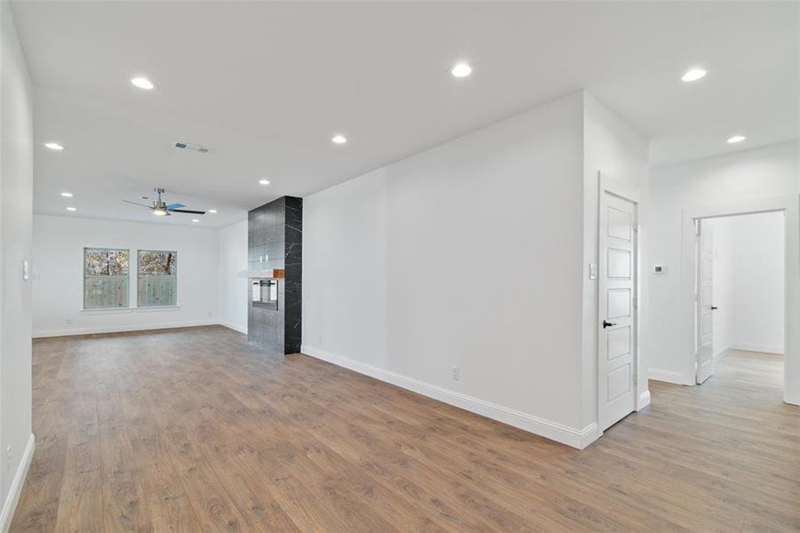 Unfurnished living room with a fireplace, hardwood / wood-style flooring, and ceiling fan