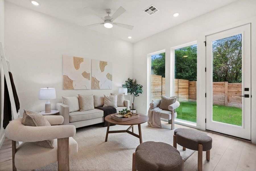 The living area features light-colored walls, a ceiling fan, and recessed lighting