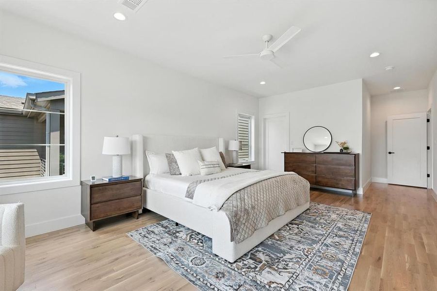 Bedroom with recessed lighting, light wood finished floors, and a ceiling fan Bedroom with recessed lighting, light wood finished floors, and a ceiling fan