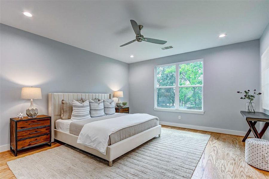 Primary suite with an abundance of natural light and engineered white oak floors.