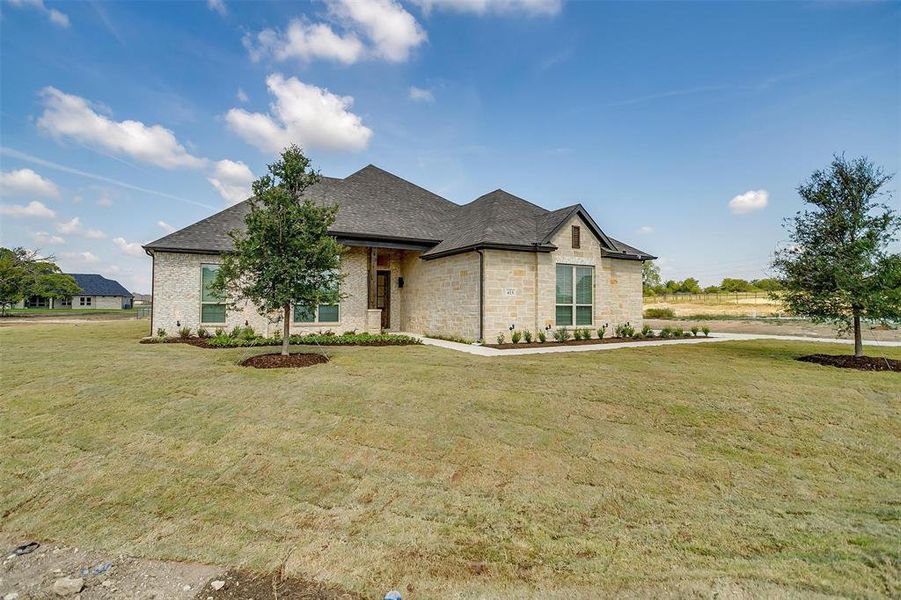 French provincial home featuring a front yard