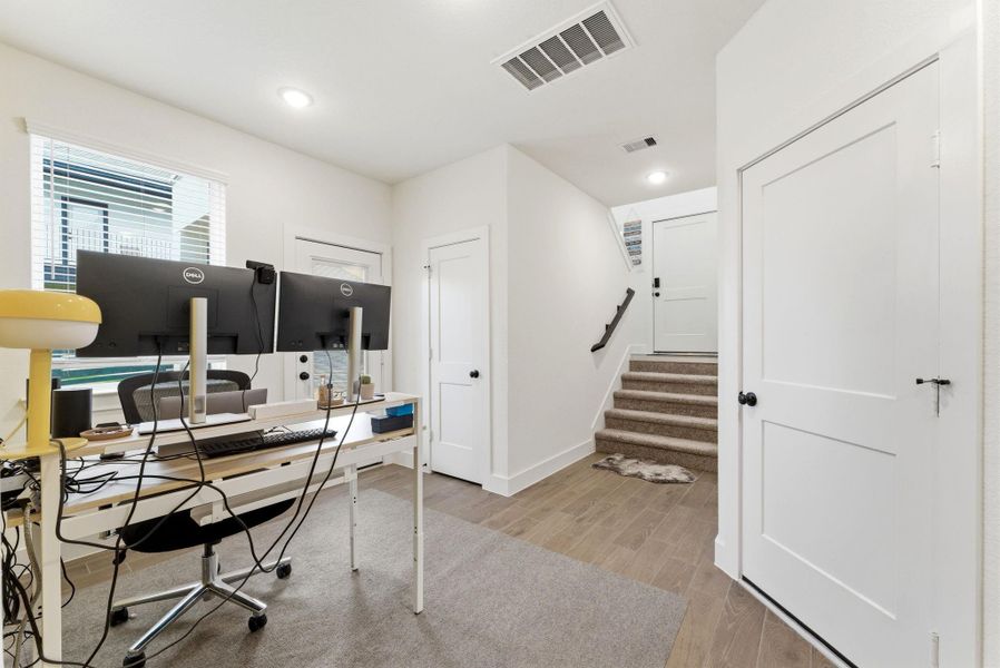 Bright and versatile first-floor flex space, perfect for a home office, creative studio, or study area with natural light and easy access to the backyard.