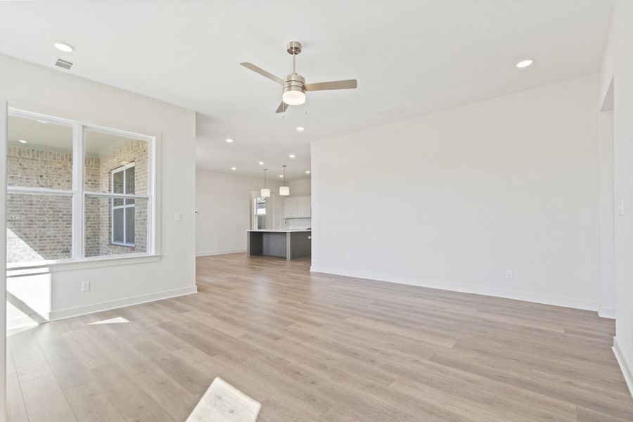 Unfurnished living room with ceiling fan, recessed lighting, and light wood finished floors