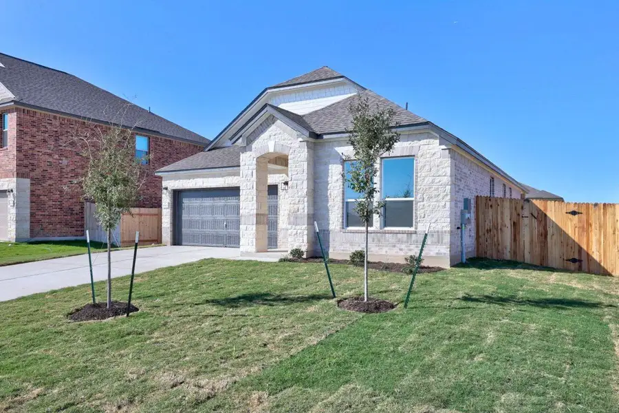 Front exterior of a new home in Mustang Valley, Manor, TX, highlighting curb appeal (Image 1).