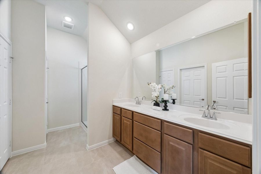 Primary ensuite bath w/ dual sinks and oversized shower