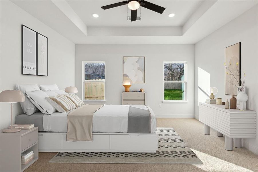 Carpeted bedroom with a tray ceiling and ceiling fan