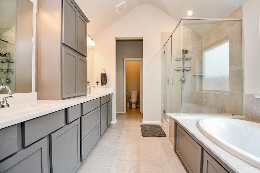 En suite bathroom with double sinks and double closets En suite bathroom with double sinks and double closets
