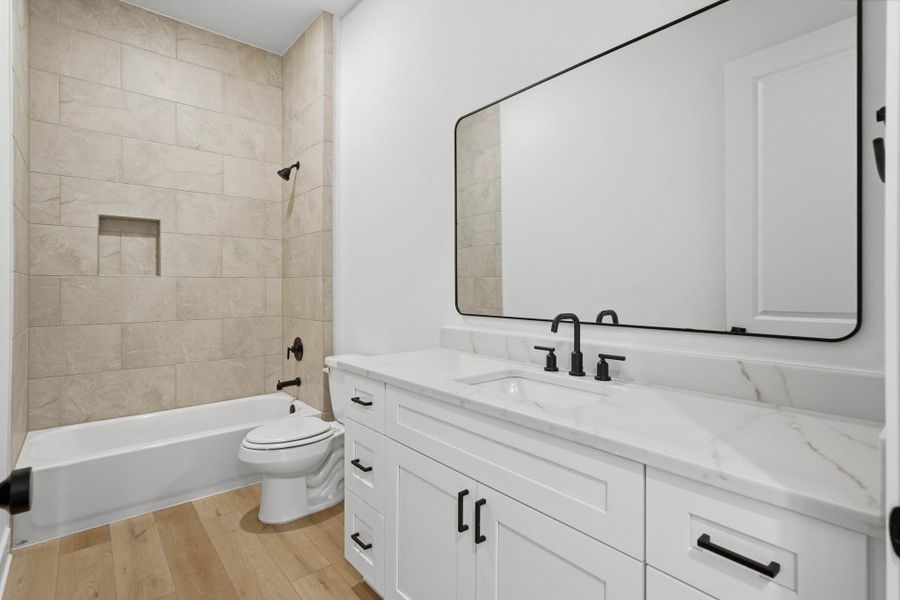 Secondary bath with high end finishes and tub/shower combo.