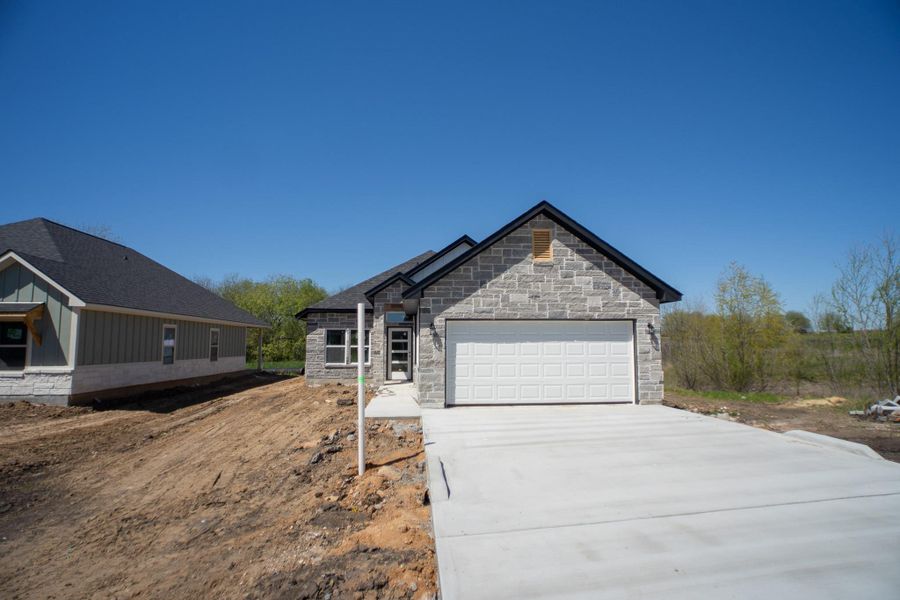 Front exterior of a new home in , Navasota, TX, highlighting curb appeal (Image 1).