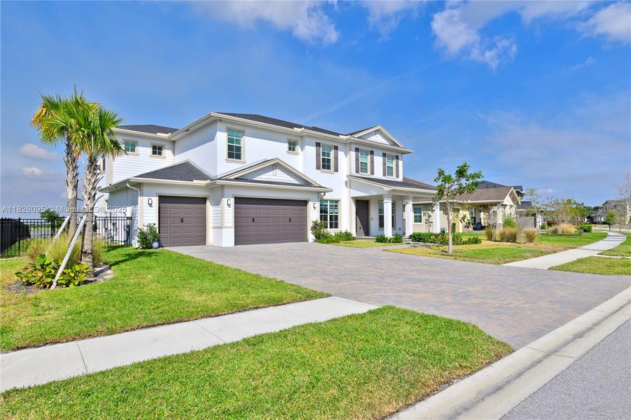 Front exterior of a new home in Arden: The Waterford Collection, Loxahatchee, FL, highlighting curb appeal (Image 27).