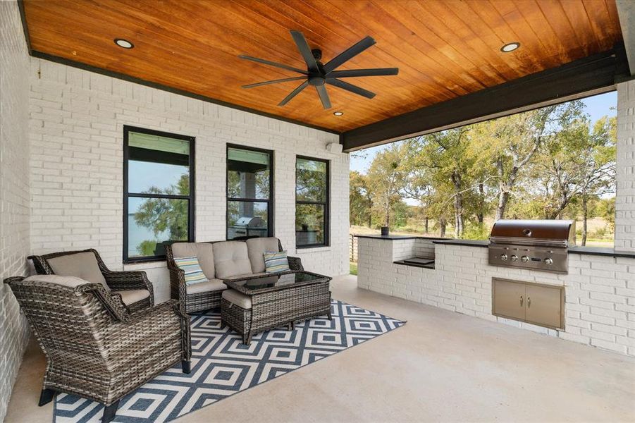 View of patio featuring outdoor lounge area, ceiling fan, area for grilling and wired for sound.