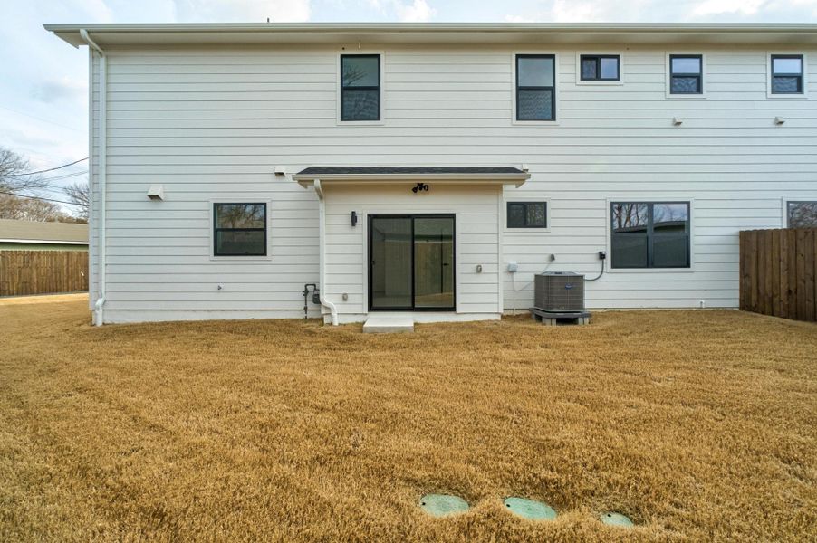 Rear view of property with a fenced backyard