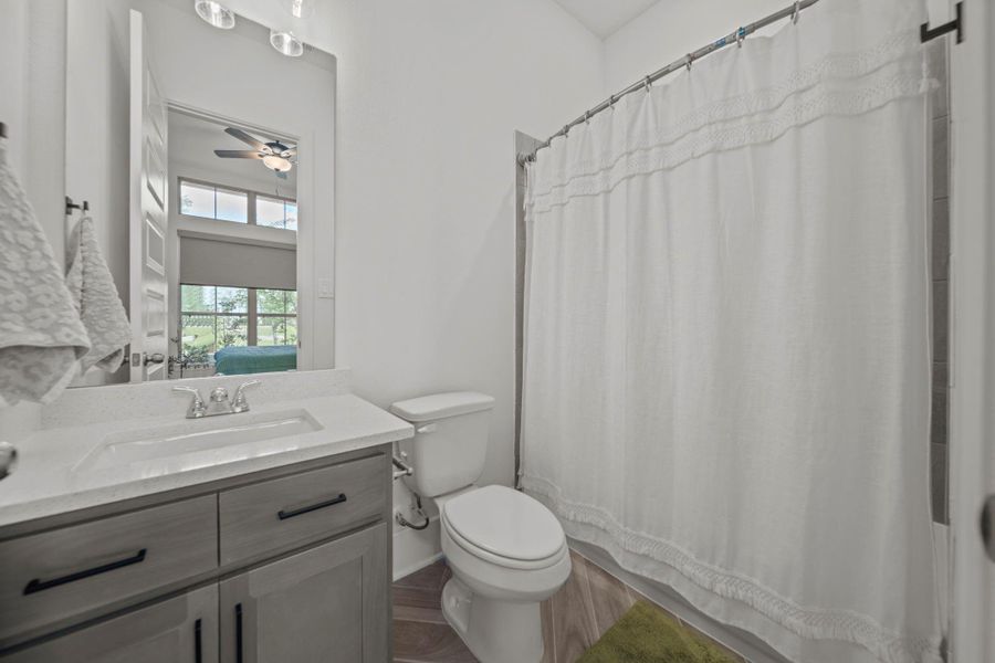Full bath ensuite to downstairs bedroom with neutral vanity, modern fixtures, and a clean design. Conveniently connected to the secondary bedroom for comfort and privacy. Full bath ensuite to downstairs bedroom with neutral vanity, modern fixtures, and a clean design. Conveniently connected to the secondary bedroom for comfort and privacy.