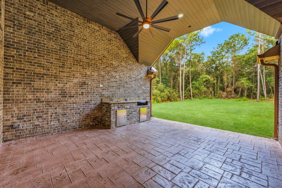 Covered patio with built-in outdoor kitchen. With dual access from game room and living area.