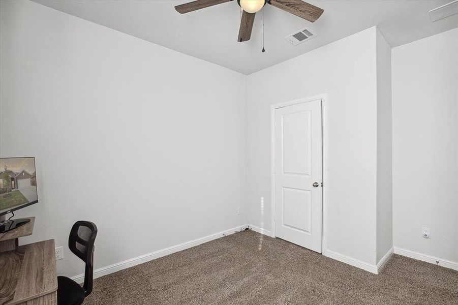 Office with ceiling fan and dark carpet Office with ceiling fan and dark carpet