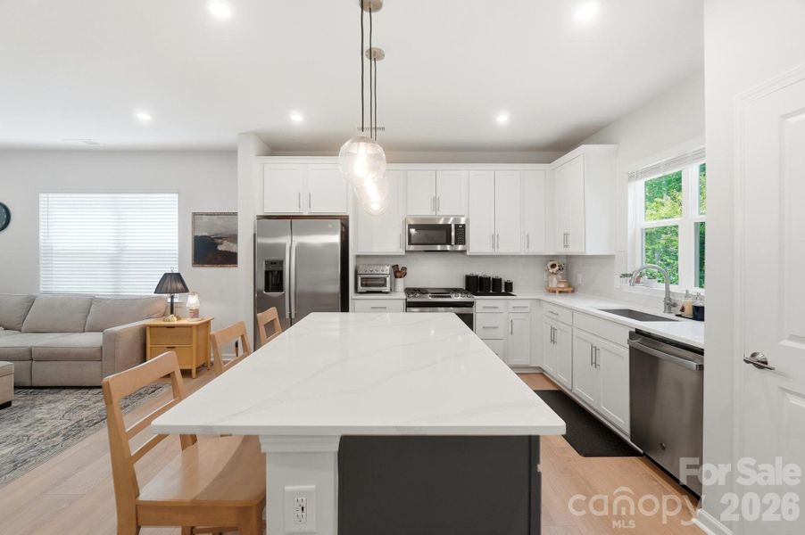 The oversized island with quartz is its own centerpiece!