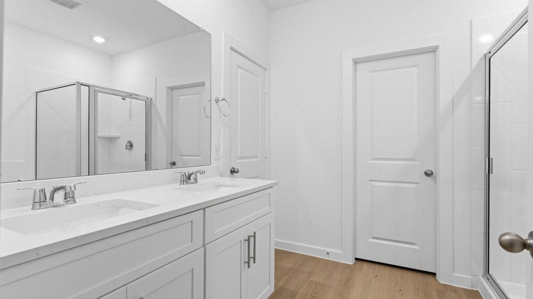 Primary bathroom with a glass-enclosed standing shower and separate soaking tub. Primary bathroom with a glass-enclosed standing shower and separate soaking tub.
