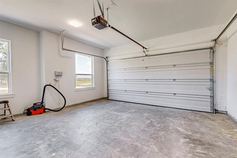 Garage featuring a garage door opener