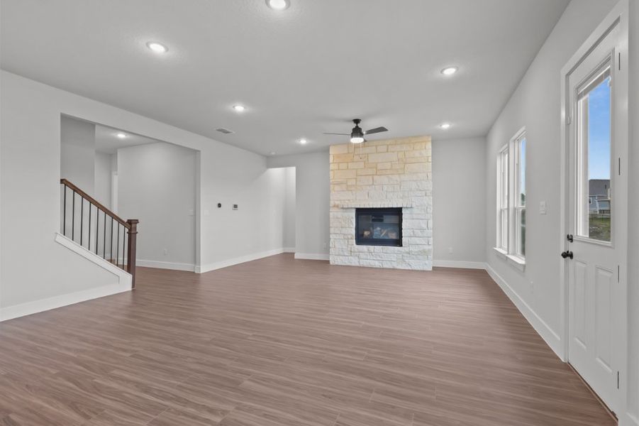 A room with a fireplace and wood floors. A room with a fireplace and wood floors.