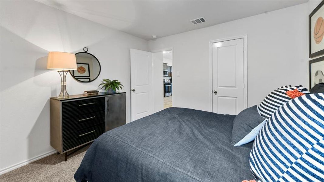 Carpeted room with white walls and a white door featuring a brushed nickel knob Carpeted room with white walls and a white door featuring a brushed nickel knob