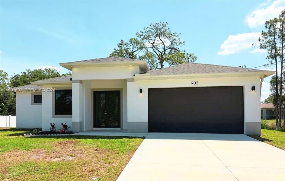 Front exterior of a new home in , Lehigh Acres, FL, highlighting curb appeal (Image 2). Front exterior of a new home in , Lehigh Acres, FL, highlighting curb appeal (Image 2).