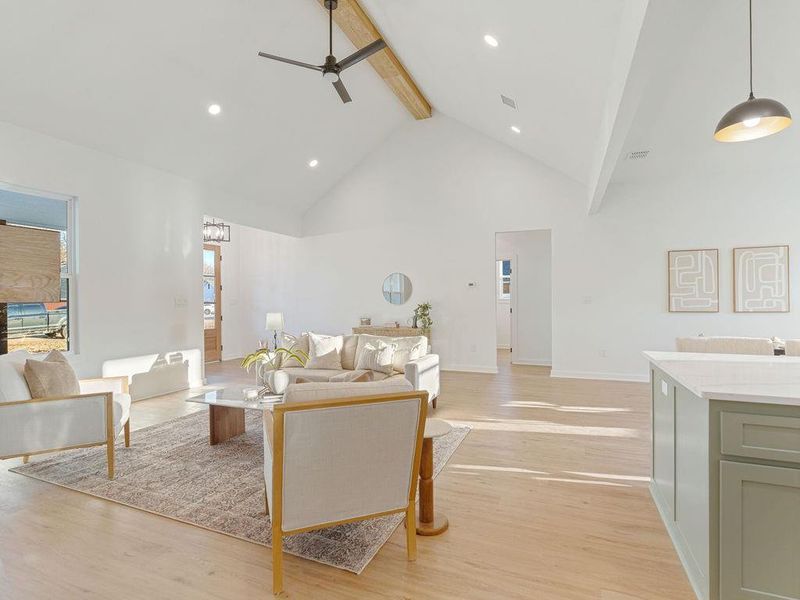 Kitchen featuring stainless steel appliances, a kitchen island, a breakfast bar area, light wood-style floors, and tasteful backsplash