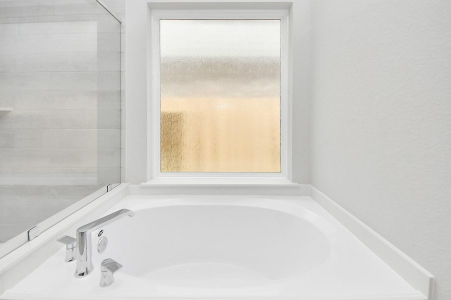 Experience a spa-like escape right in the heart of your primary bathroom! Sample photo of completed home with similar floor plan. Actual colors and selections may vary.