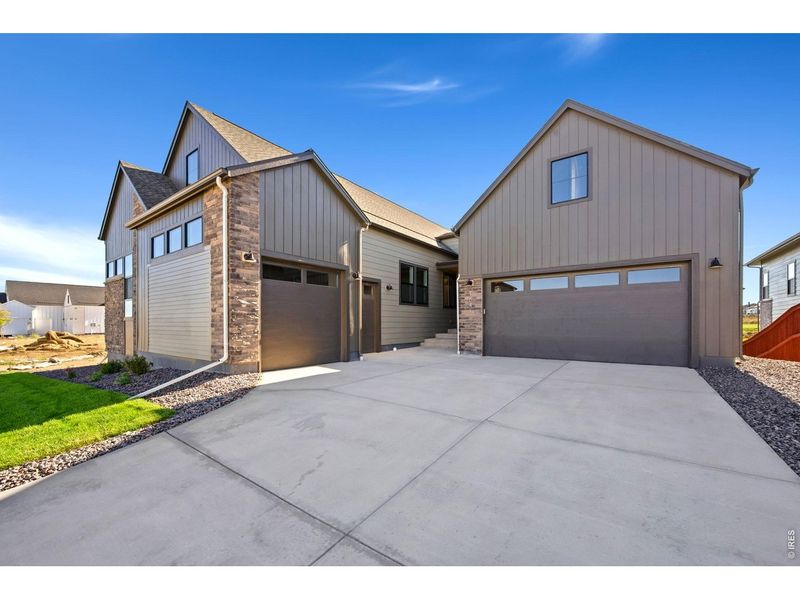 Front exterior of a new home in RainDance, Windsor, CO, highlighting curb appeal (Image 2).