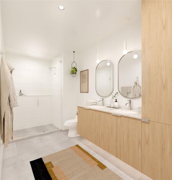 The primary bathroom greets you with large ceramic floor tiles, soft under cabinent light, an oversized shower featuring a generously sized built-in shower shelf, and double vanities.