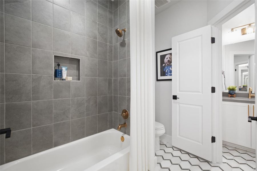 Full bath with shower / bath combination with curtain and vanity