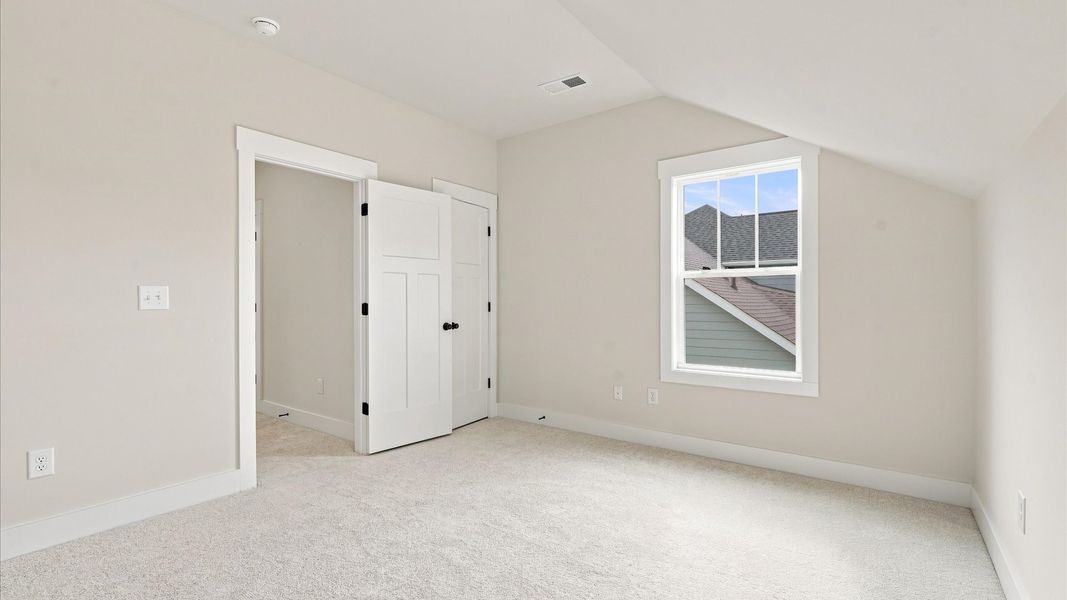 Refined bedroom design with a large window for daylight-filled mornings and peaceful views in Seneca, SC