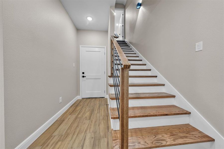 Stairway featuring wood finished floors and baseboards Stairway featuring wood finished floors and baseboards