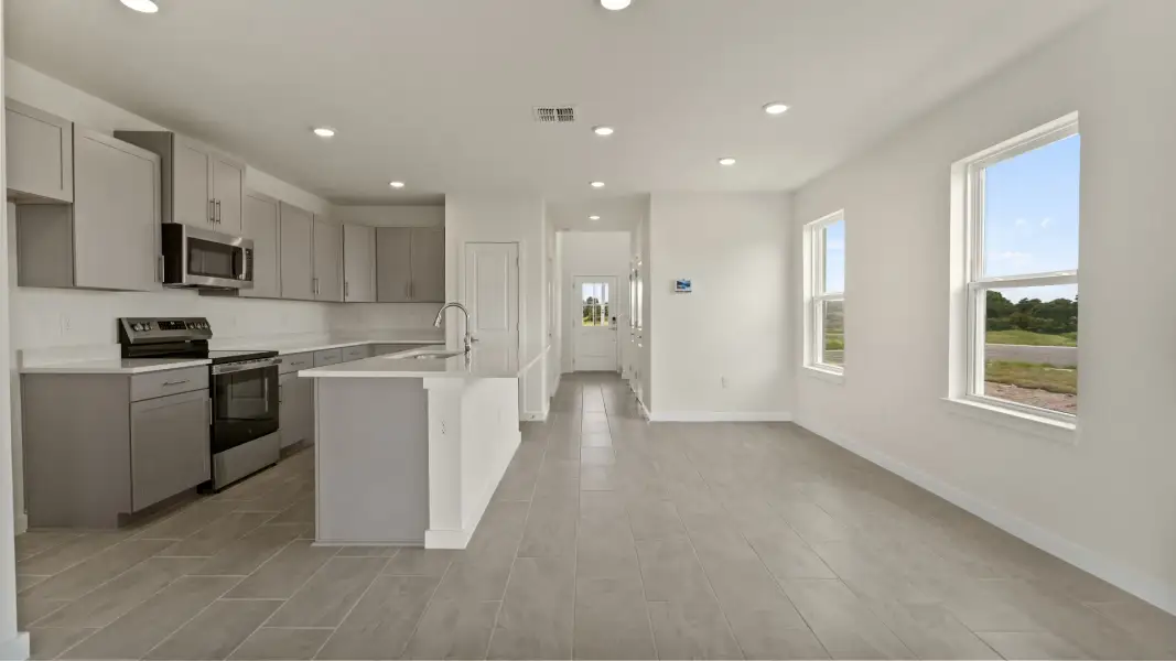 The Naples Kitchen with large Island Quick Move-In Home at Willowbrook North by DRB Homes in Winter Haven, FL