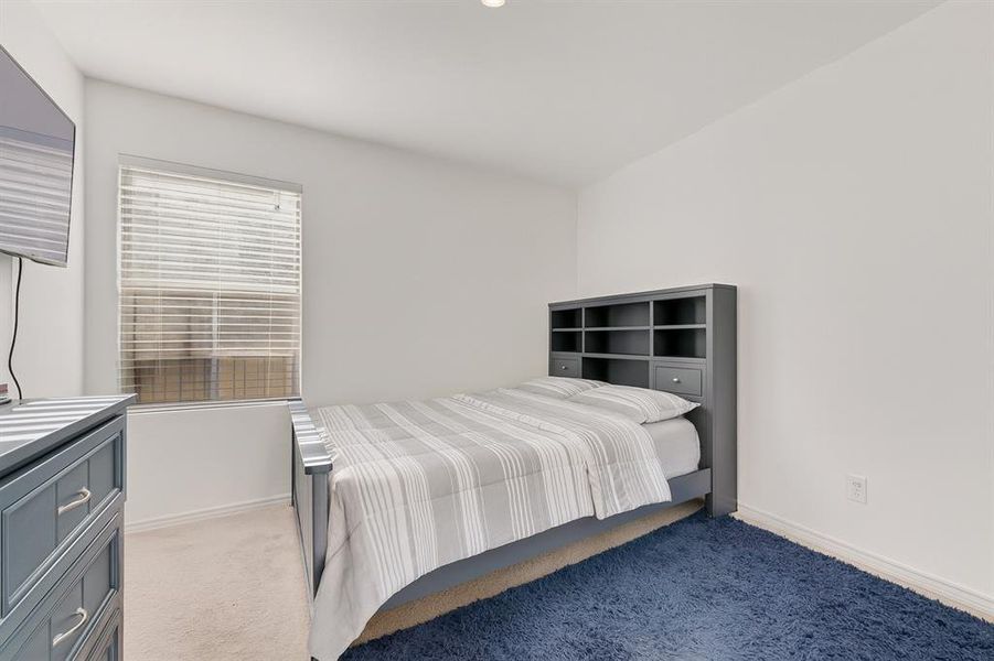 Bedroom with light colored carpet and baseboards Bedroom with light colored carpet and baseboards