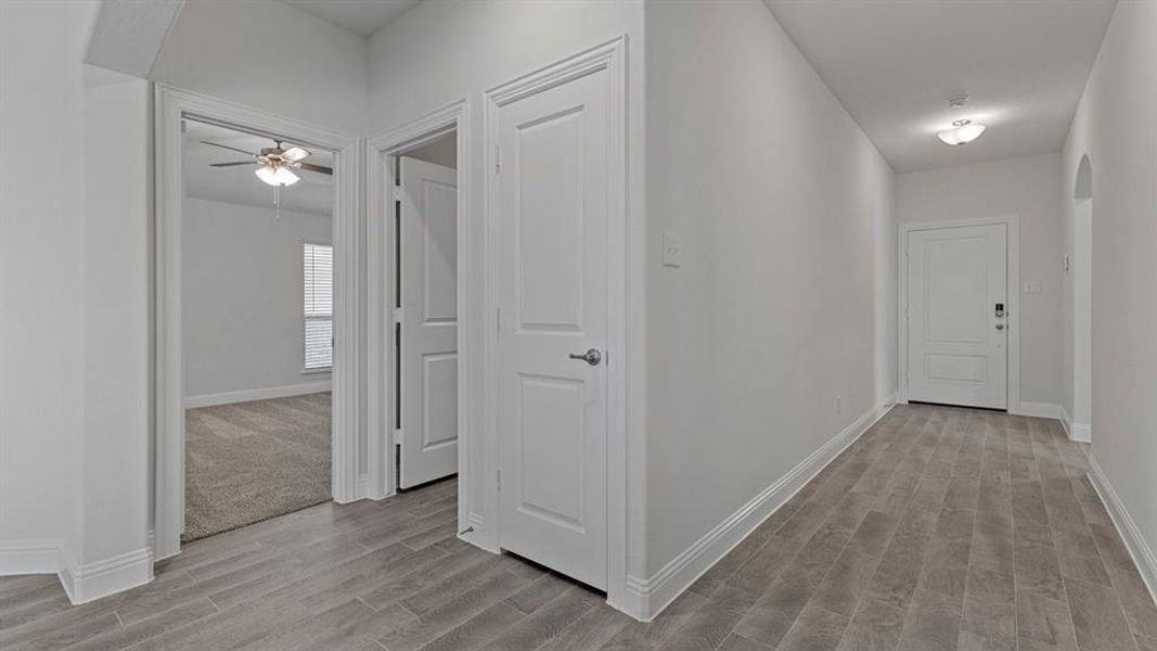 Corridor with arched walkways and wood tiled floors