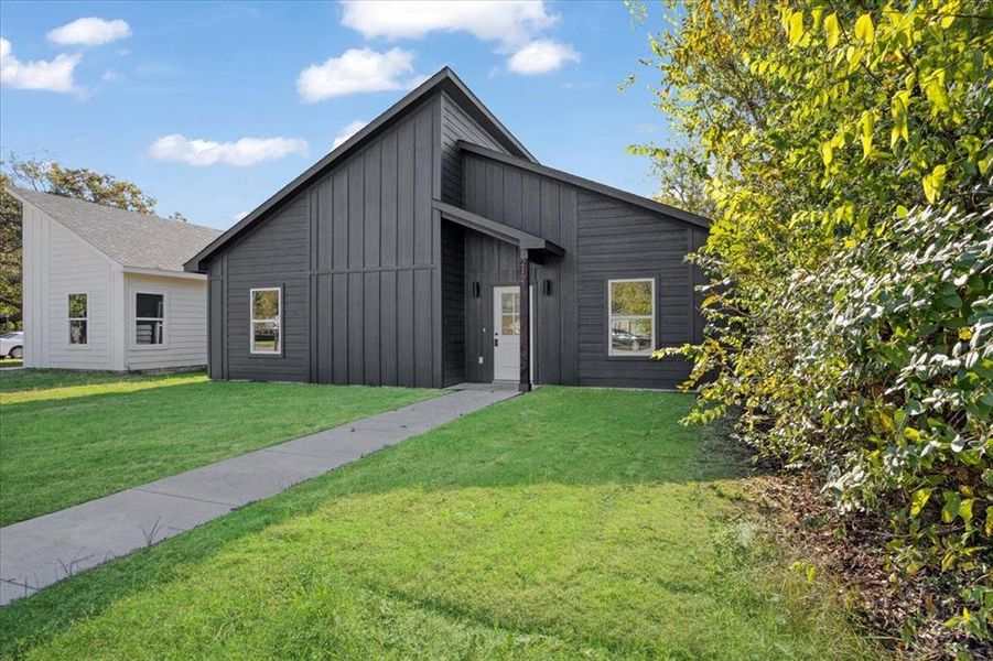 View of front of property with a front yard