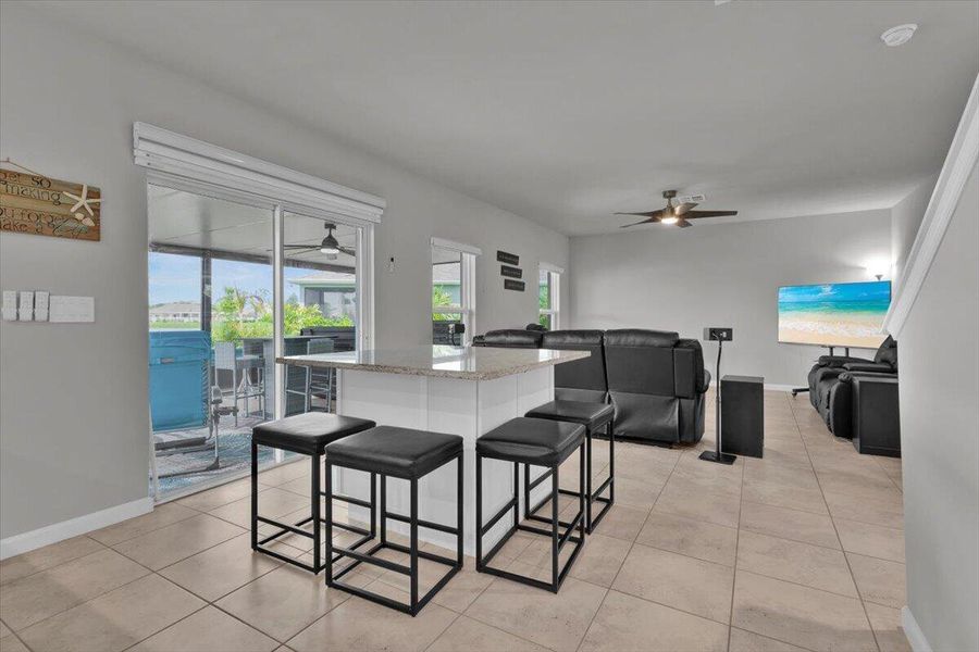 The added cabinets and countertop add storage and seating in the open kitchen and living area
